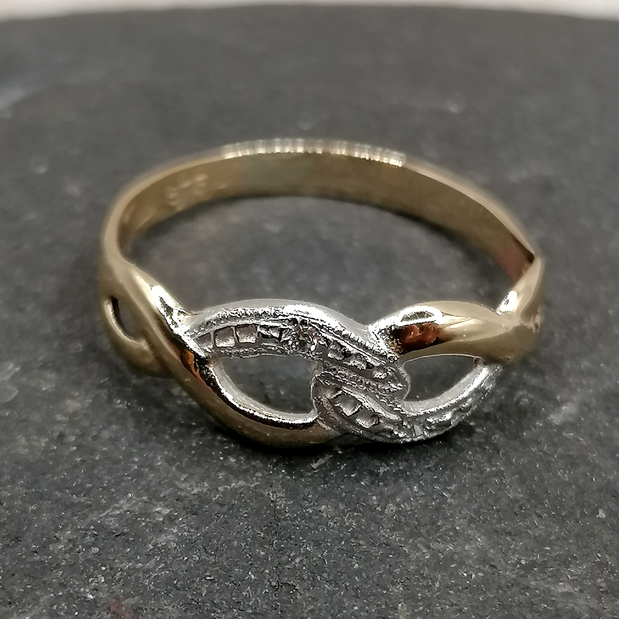 Nine carat knot dress ring with diamonds