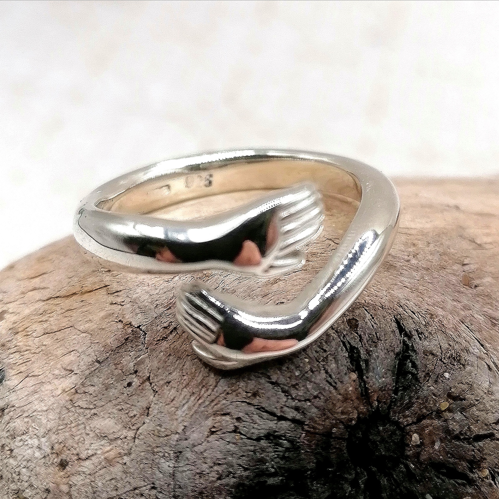 Hugging hands silver ring